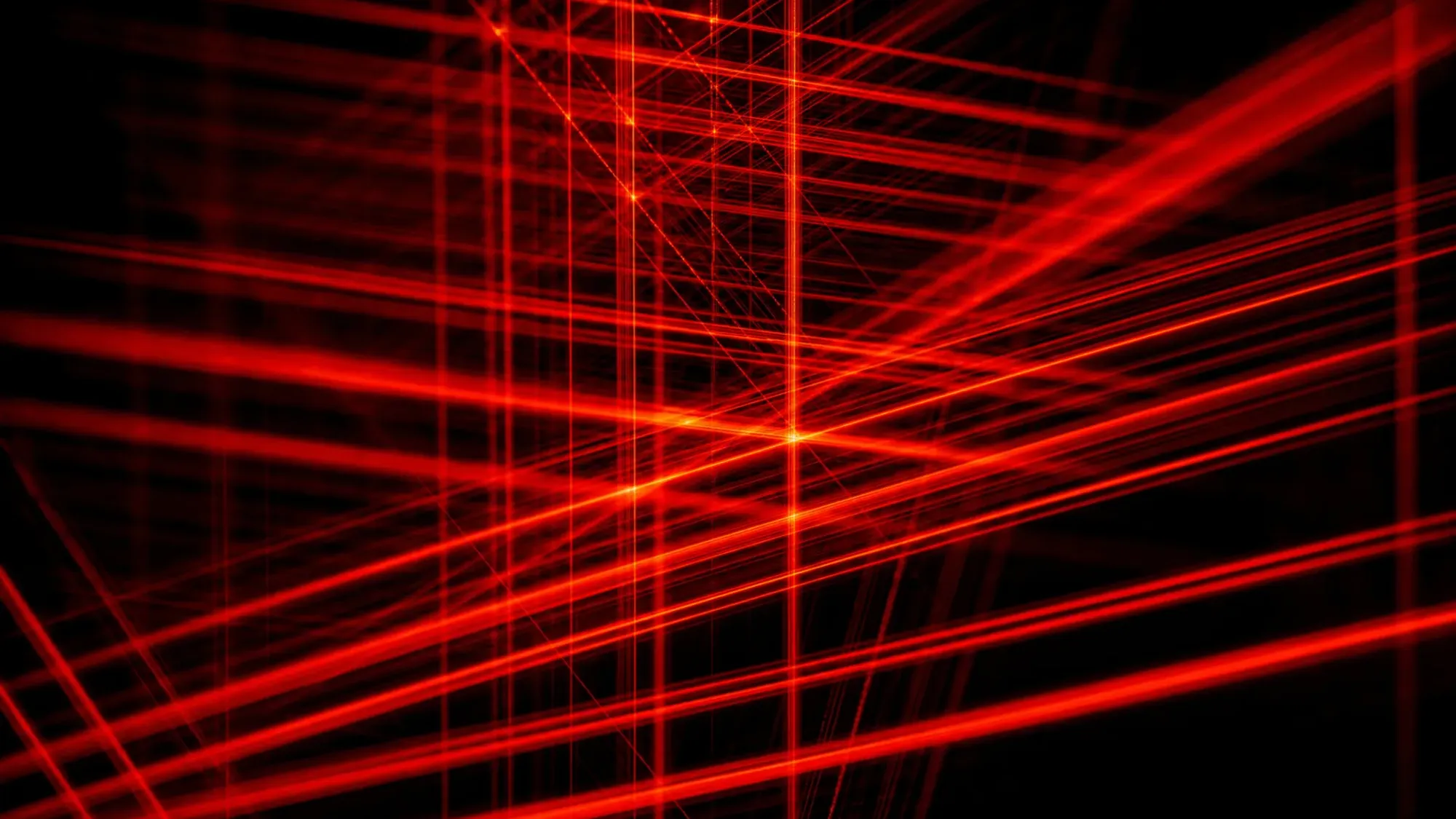 Des faisceaux de lumière rouges se croisant pour former un treillis sur fond noir